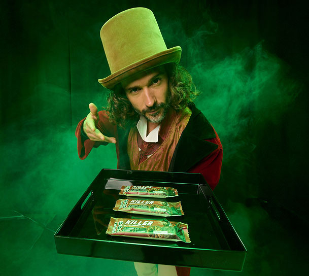 Joe with tray of Killer Bars on green smoke background